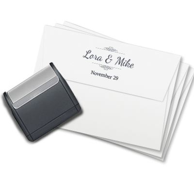 Large black Modico self-inking stamp with black ink laying flat on a set of white envelopes, displaying the print of the stamp